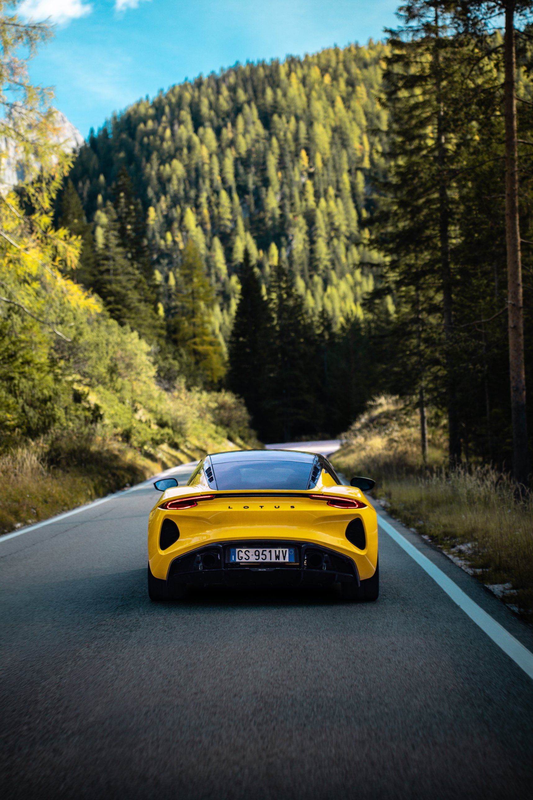 Lotus Emira on a forest road in the Dolomites