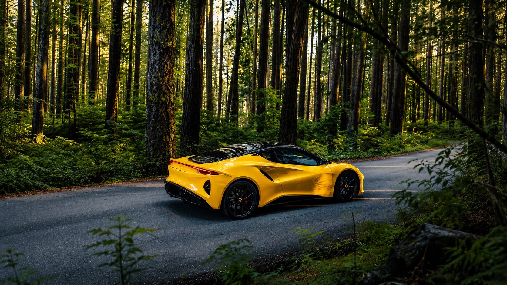 Gelber Lotus Emira V6 First Edition auf einer kurvigen Straße